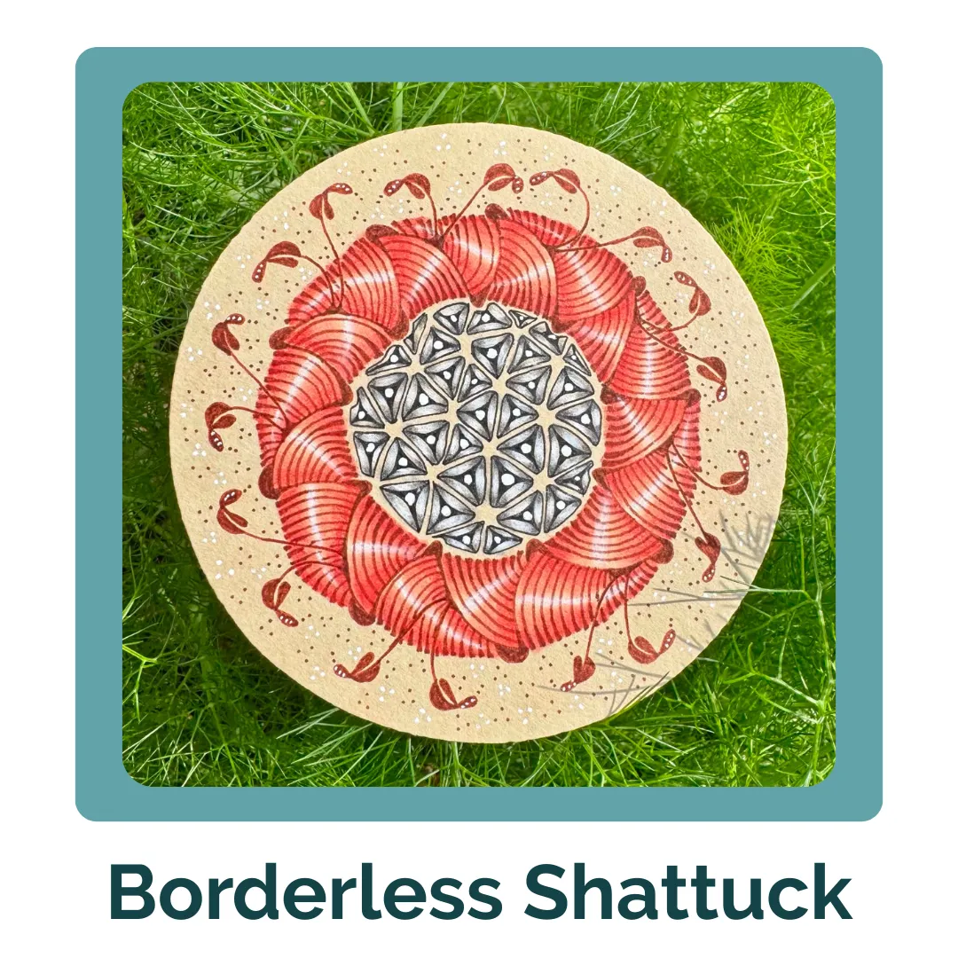 A circular tan Zentangle tile featuring a vibrant, reddish-coral 'Shattuck' pattern woven into a wreath shape. The center contains an intricate black-and-white geometric pattern of triangles. The artwork is nestled outdoors in a lush background of bright green, feathery dill or fennel leaves.
